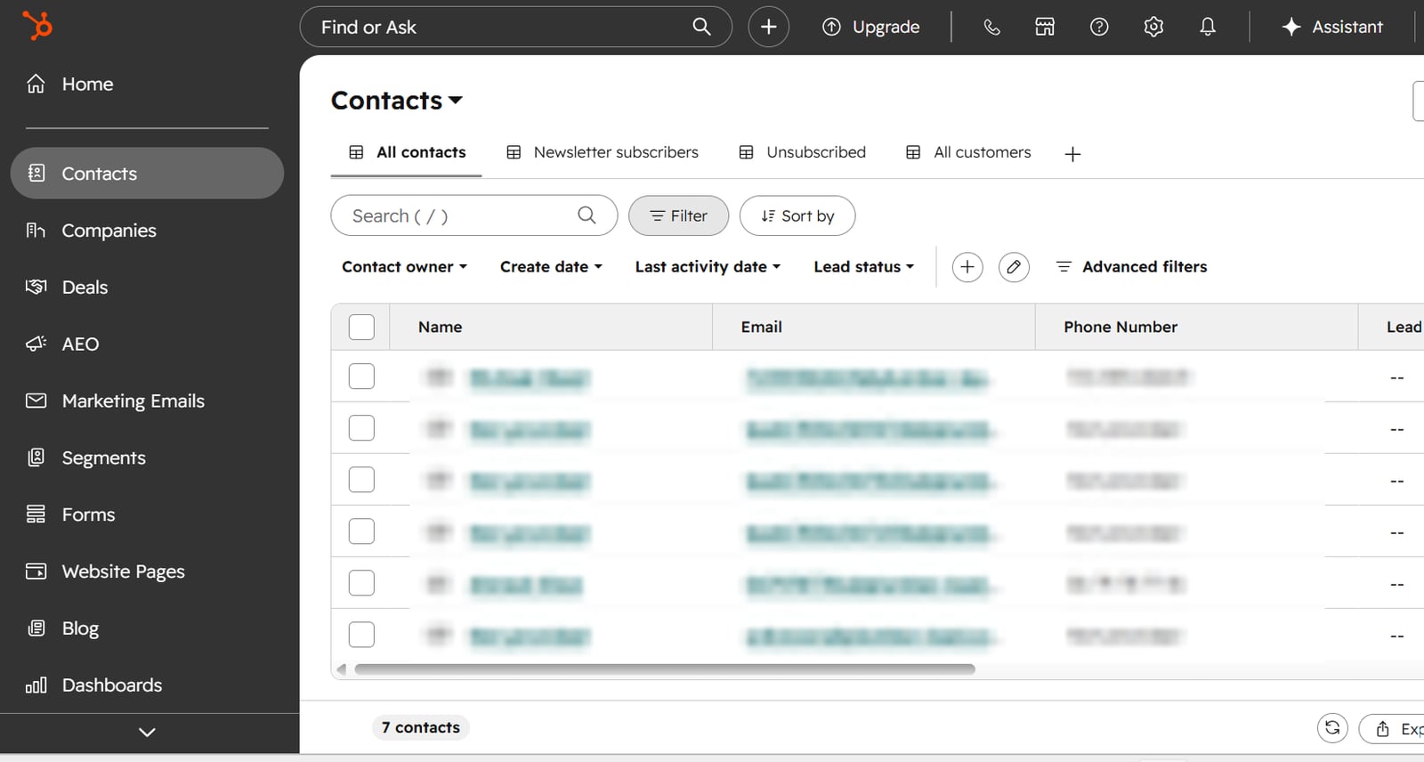 HubSpot contacts list showing contacts created by the receptionist, with names, emails and phone numbers blurred